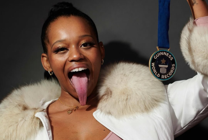 Chanel Tapper smiling holds Guinness World Record with pride